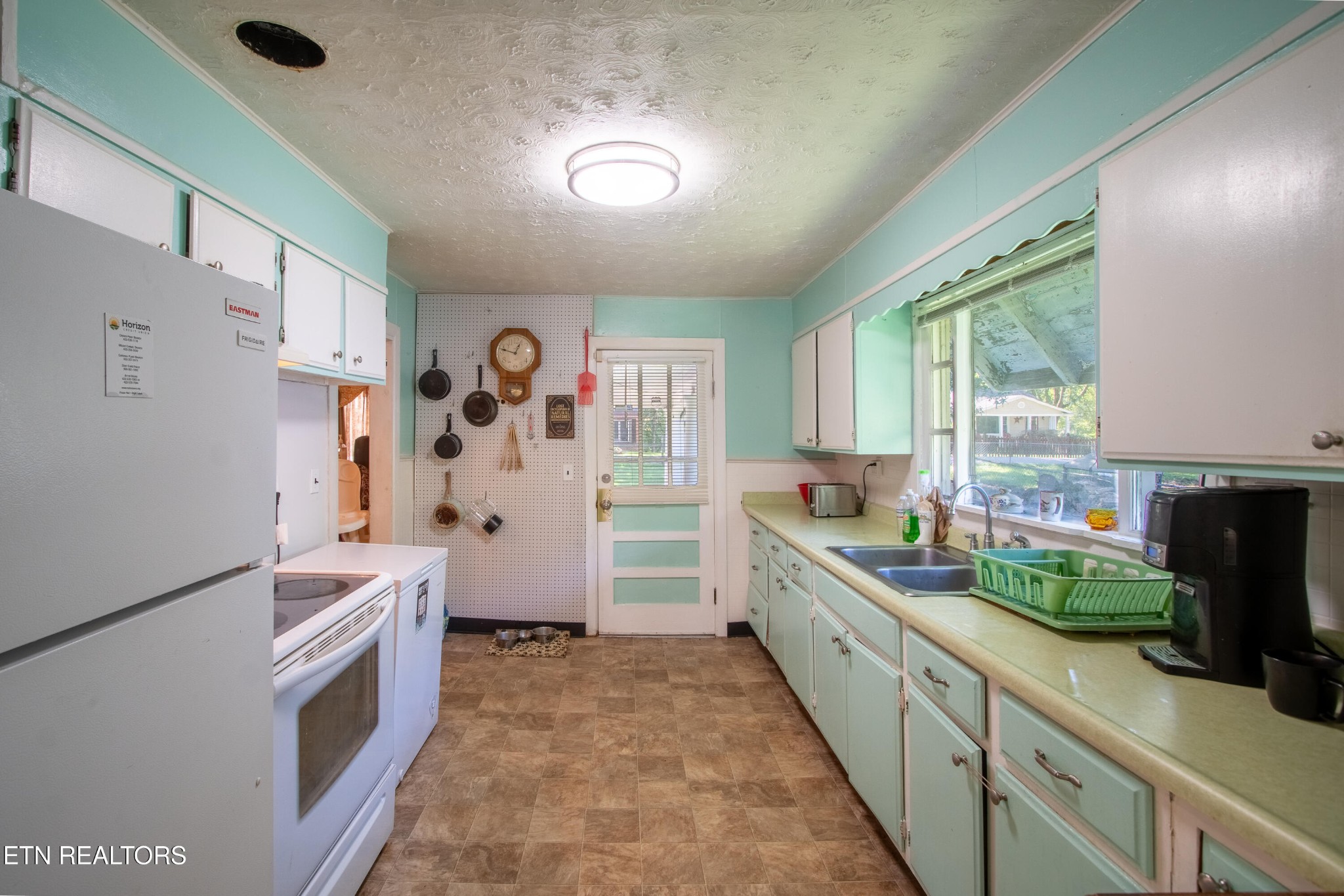 2316 Reservoir Road Kingsport, TN 37660 - Photo 8 of 22 a kitchen with granite countertop a refrigerator and a stove top oven