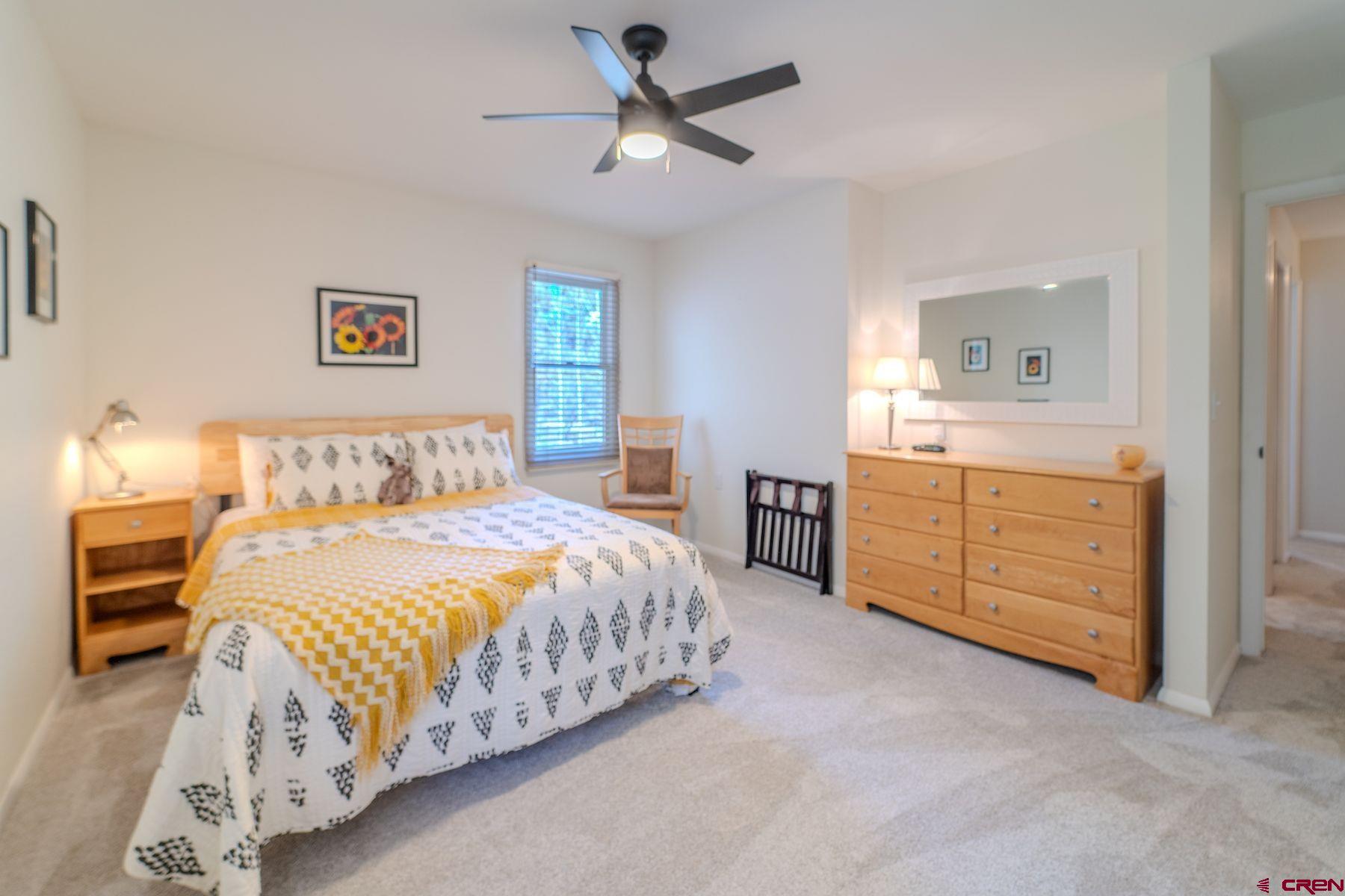 34 Crocus Court Durango, CO 81301 - Photo 23 of 30 a bedroom with a bed and a chandelier