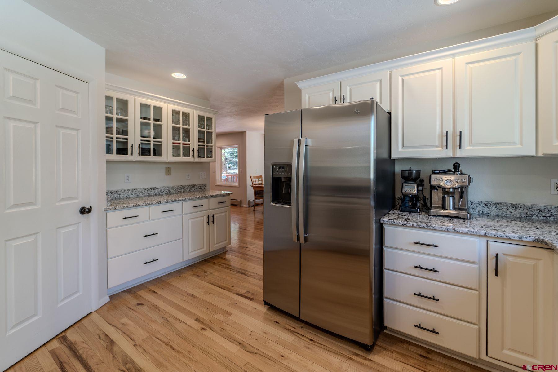 34 Crocus Court Durango, CO 81301 - Photo 9 of 30 a kitchen with white cabinets and stainless steel appliances
