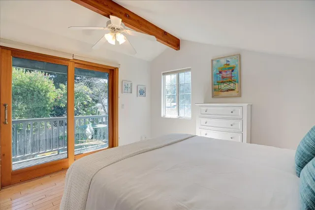 a bedroom with a bed and a large window with outer view