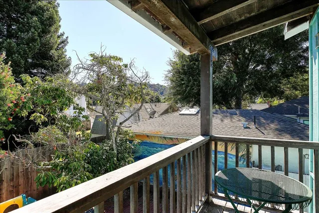 a view of a balcony with wooden floor