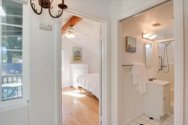a view of a hallway with wooden floor and entryway
