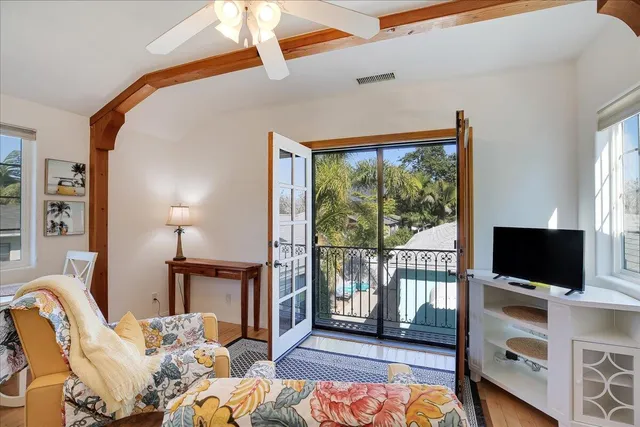 a bedroom with furniture and a flat screen tv
