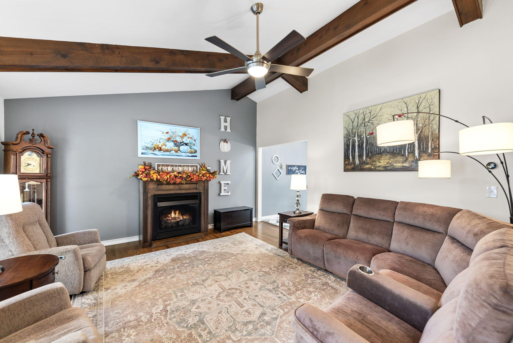 9835 Arthur Court Crown Point, IN 46307 - Photo 2 of 27 a living room with furniture a fireplace and a flat screen tv