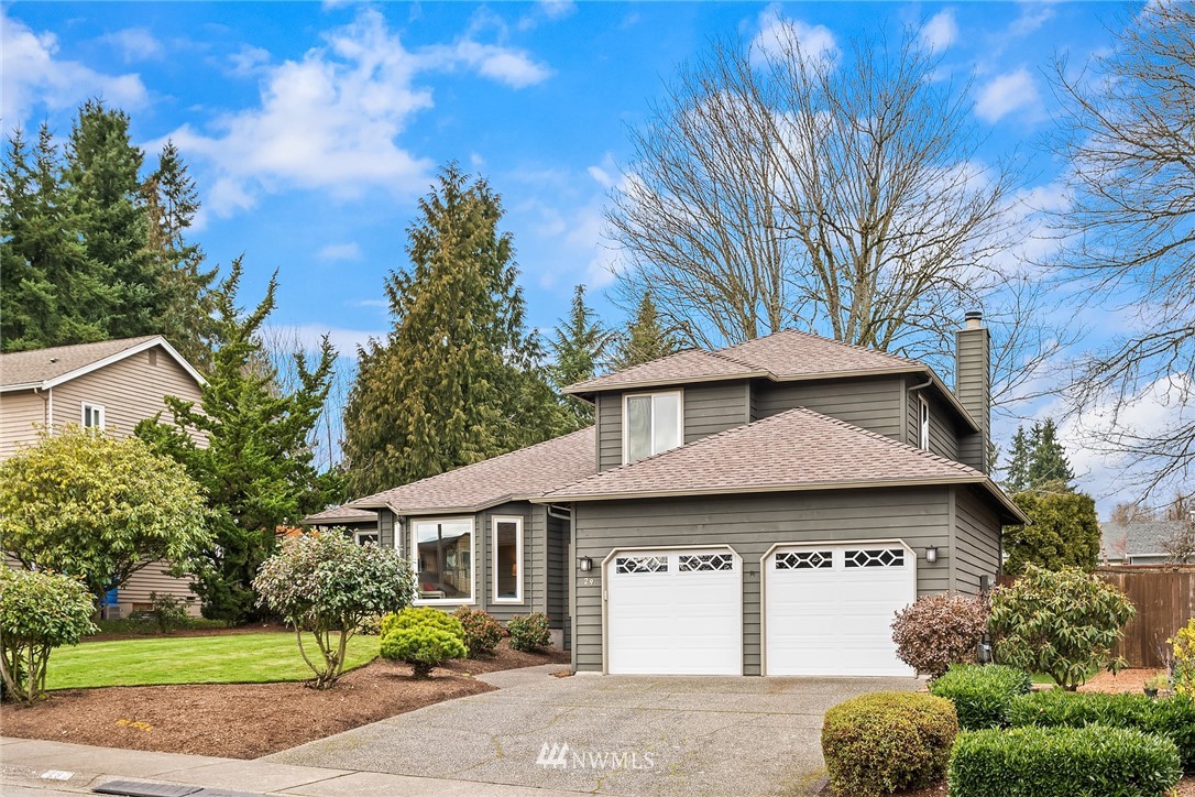 29 236th Place Southwest Bothell, WA 98021 - Photo 3 of 36 a front view of a house with a yard and garage