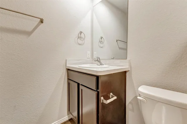 a bathroom with a sink toilet and a mirror