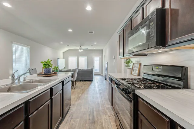 a kitchen with stainless steel appliances a sink stove and cabinets