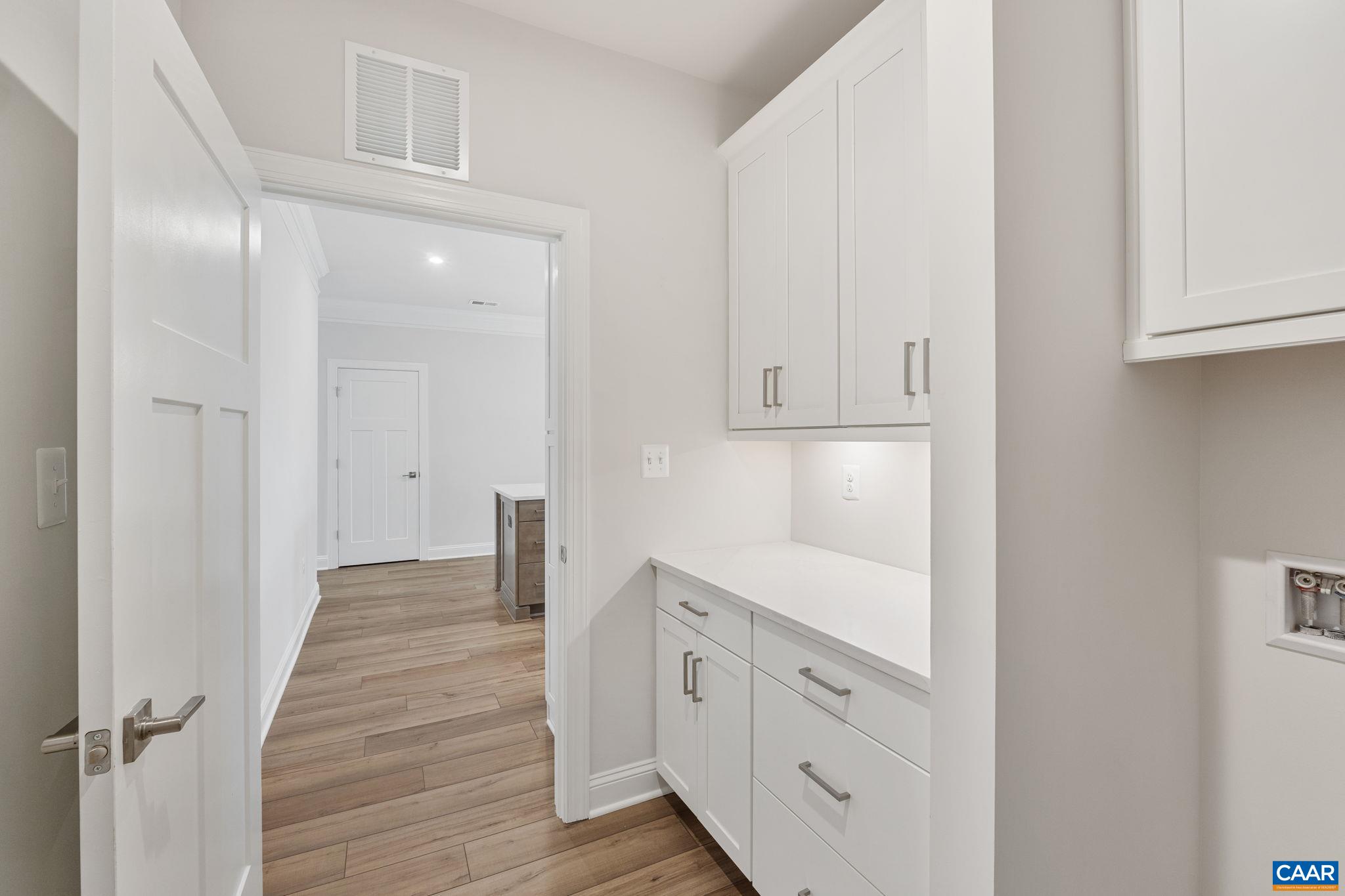 201 Ridgeline Drive Waynesboro, VA 22980 - Photo 23 of 45 a hallway with white cabinets and wooden floor