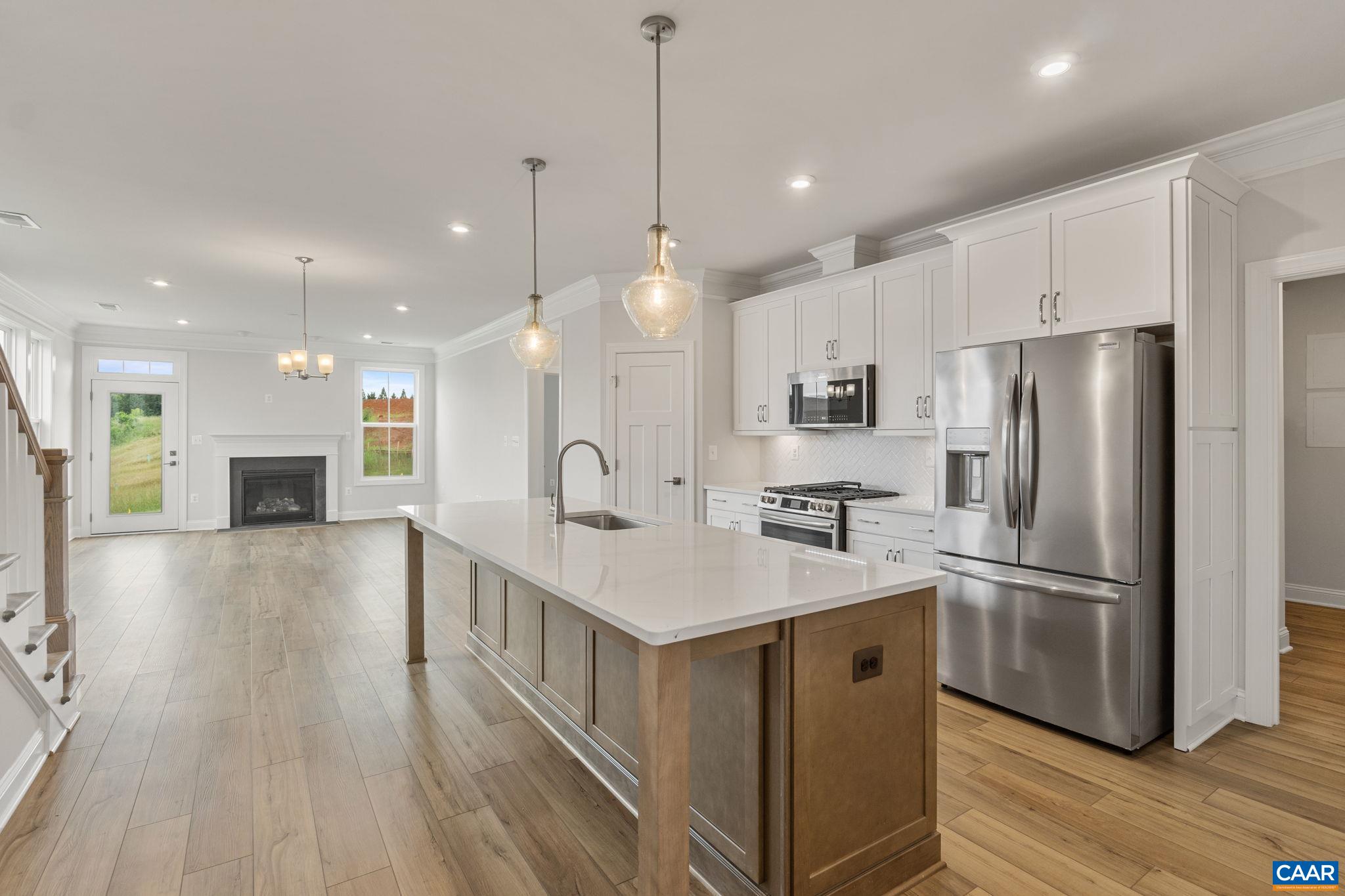 201 Ridgeline Drive Waynesboro, VA 22980 - Photo 8 of 45 a kitchen with stainless steel appliances kitchen island a sink and a refrigerator