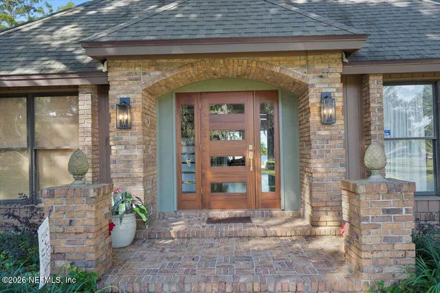 a bedroom with a bed a dresser next to a window