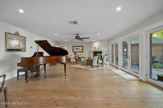 a view of house with swimming pool and outdoor seating