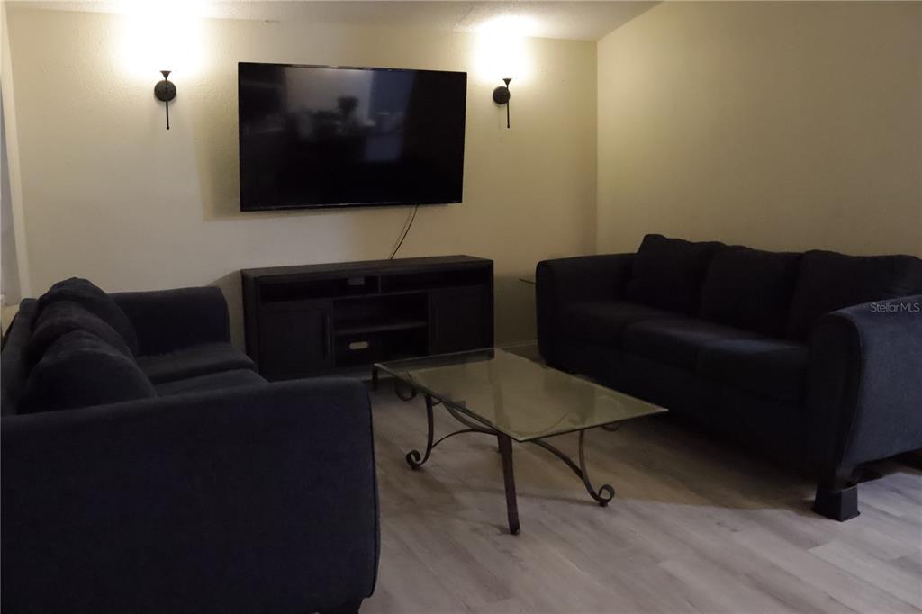 3856 South Sandpiper Terrace Homosassa, FL 34448 - Photo 5 of 27 a living room with furniture and a flat screen tv