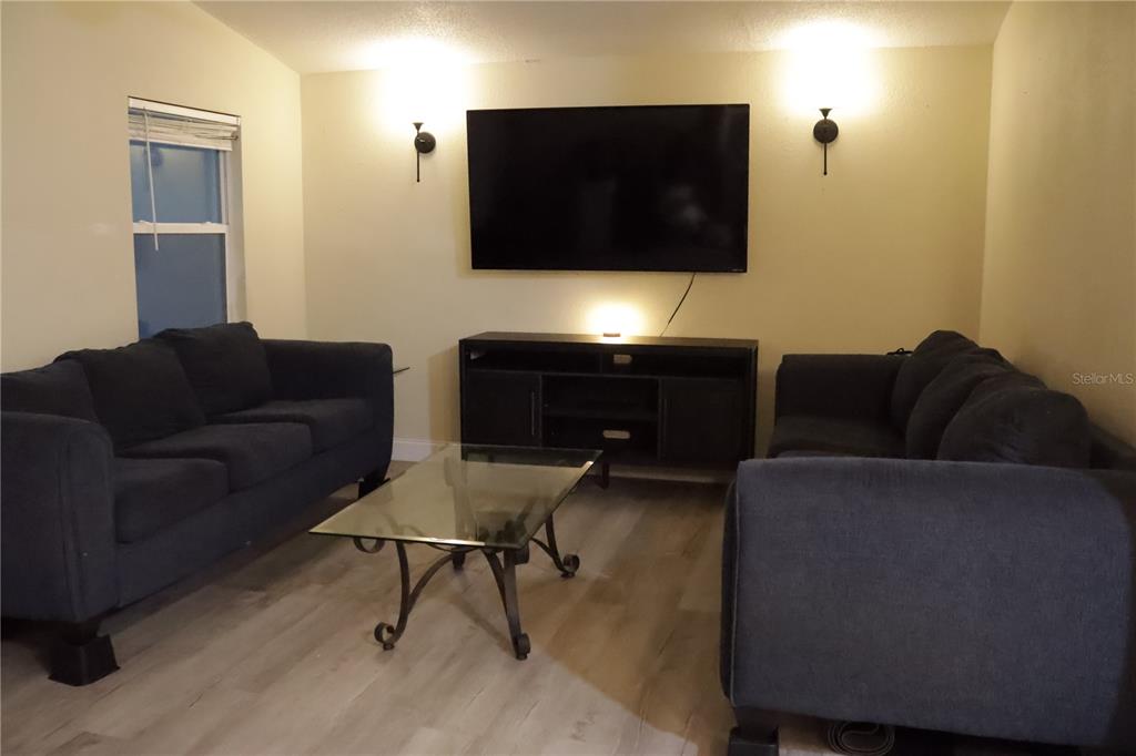 3856 South Sandpiper Terrace Homosassa, FL 34448 - Photo 6 of 27 a living room with furniture and a flat screen tv