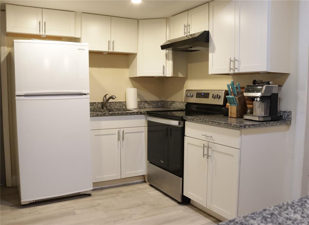 3856 South Sandpiper Terrace Homosassa, FL 34448 - Photo 9 of 27 a kitchen with white cabinets and refrigerator