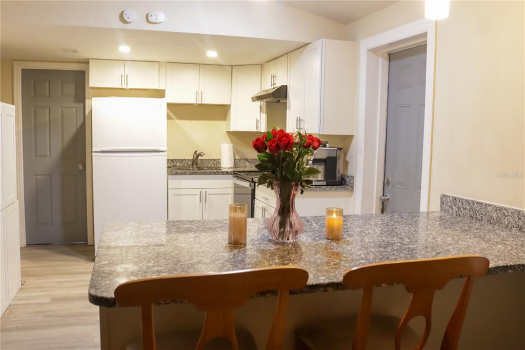 3856 South Sandpiper Terrace Homosassa, FL 34448 - Photo 10 of 27 a kitchen with stainless steel appliances granite countertop a refrigerator a sink and white cabinets