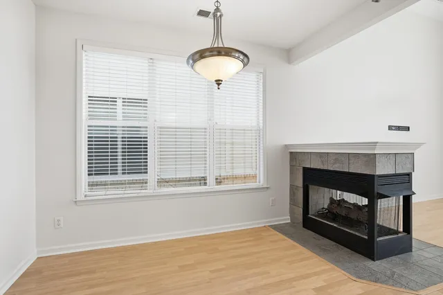 a living room with a fireplace and a window