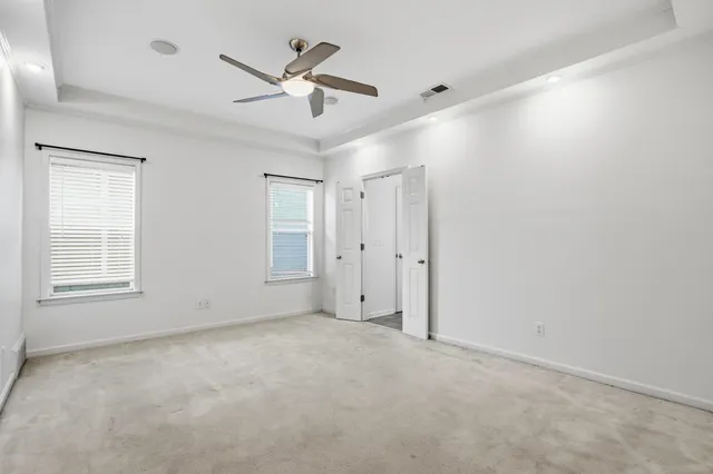 a view of an empty room with a ceiling fan