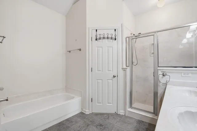 a bathroom with a tub a sink and a shower