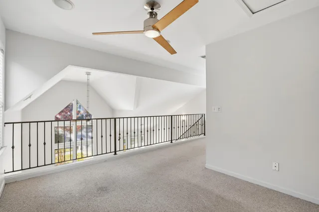 a view of empty room with windows and fan