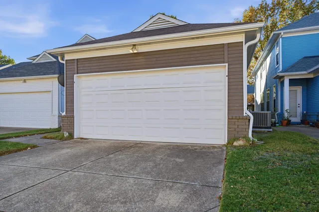 a front view of a house with a tree