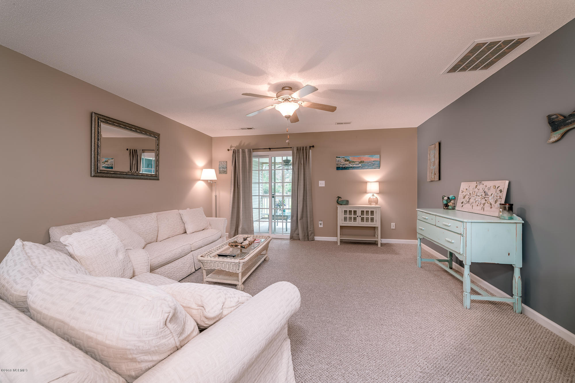 601 Peletier Loop Road, Unit I54 Swansboro, NC 28584 - Photo 3 of 13 Living Room View from Kitchen - Sliding Door leading to Private Screened Porch and laundry room