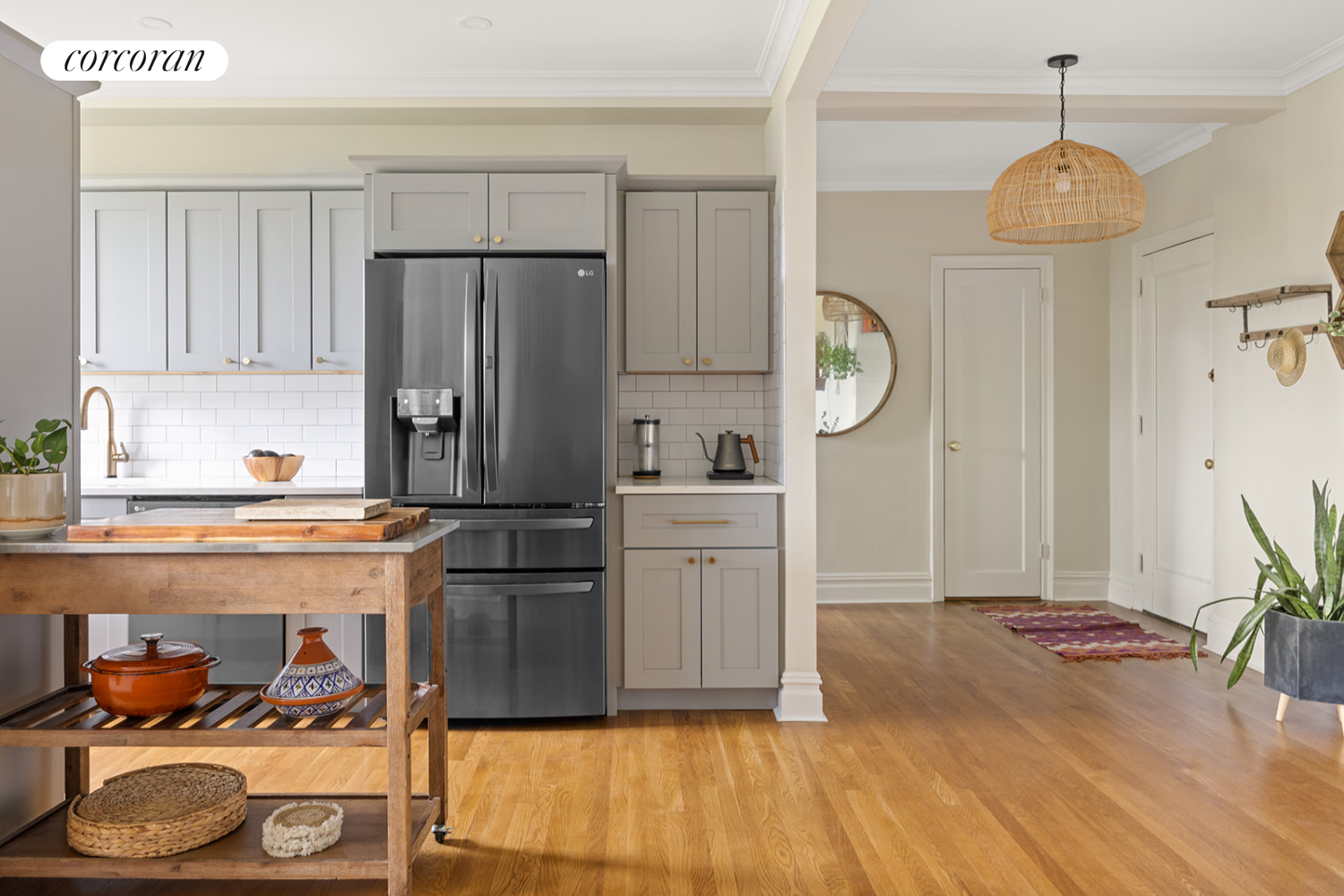 a kitchen with granite countertop a refrigerator a stove and wooden floor