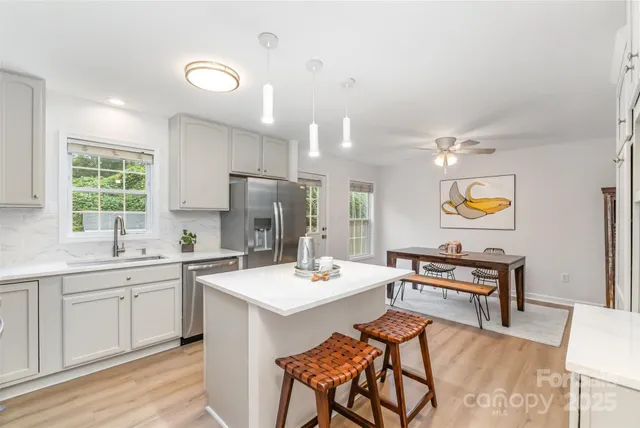 a kitchen with a sink cabinets and wooden floor