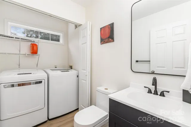 a bathroom with a sink and a washer dryer
