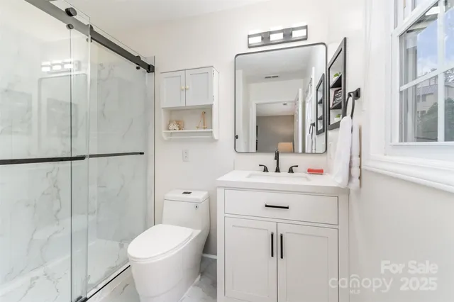 a bathroom with a sink toilet and shower