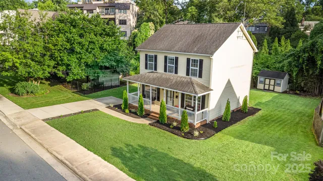 an aerial view of a house with a yard