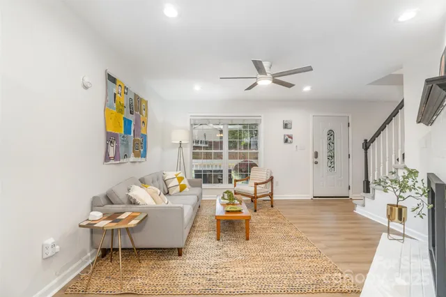 a living room with furniture and wooden floor