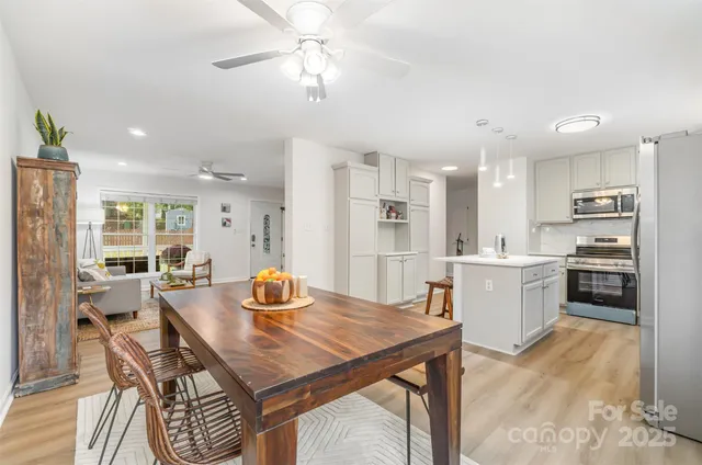 a view of a dining room with furniture and a kitchen
