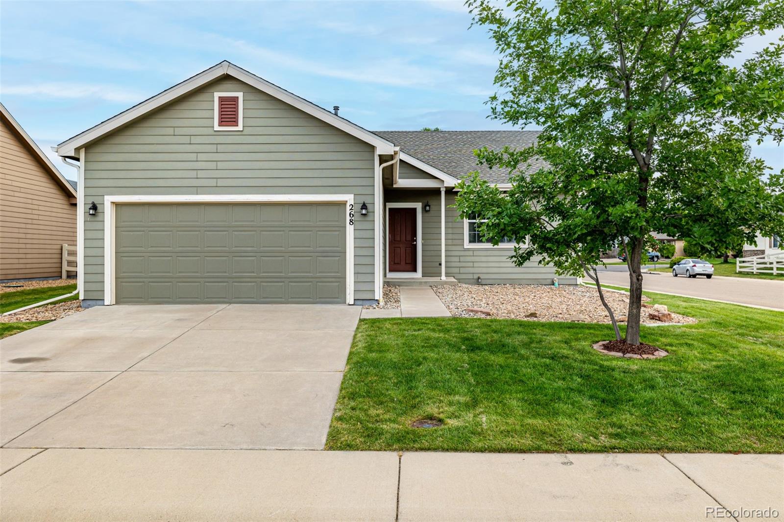 a small white building with a yard