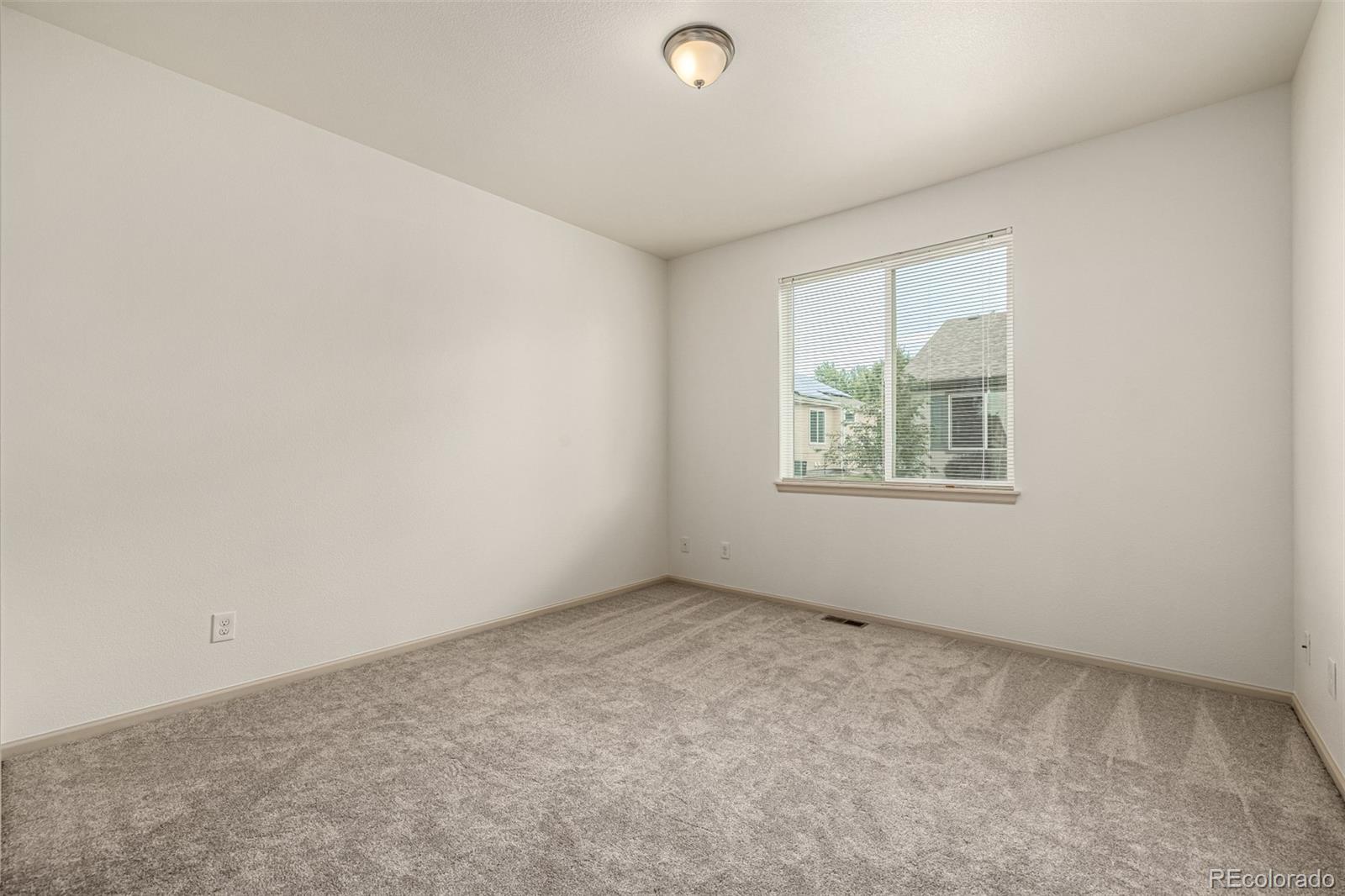 268 Naples Street Firestone, CO 80520 - Photo 15 of 34 an empty room with windows