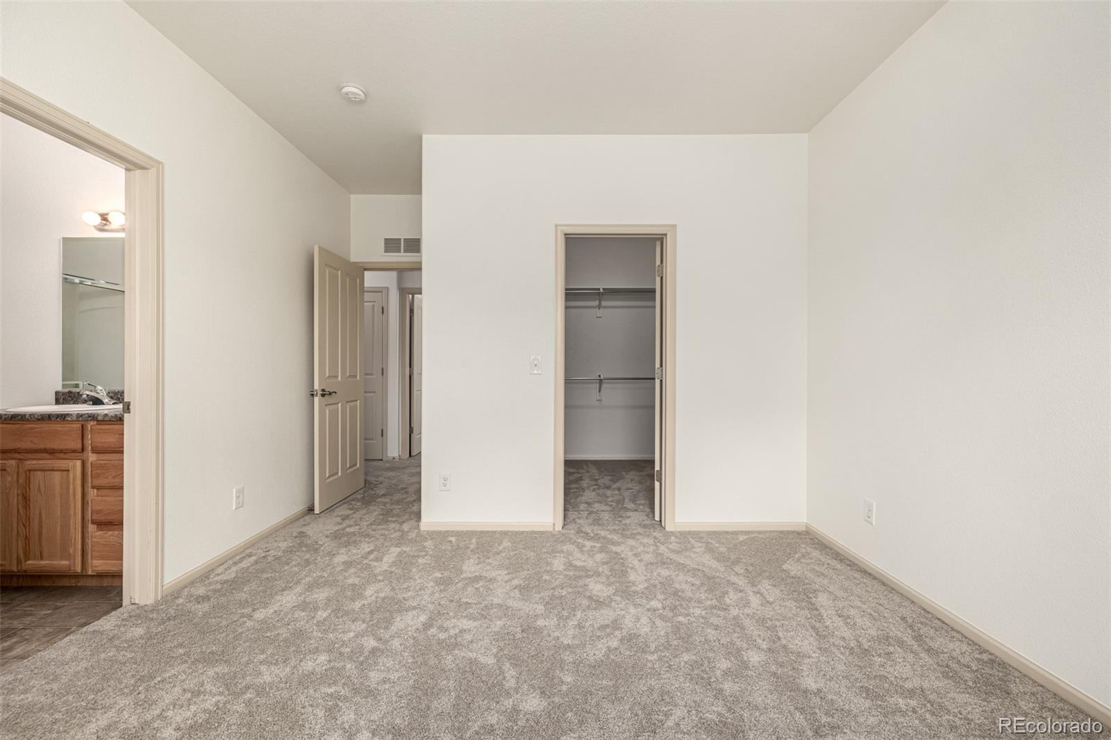 268 Naples Street Firestone, CO 80520 - Photo 16 of 34 an empty room with closet and mirror