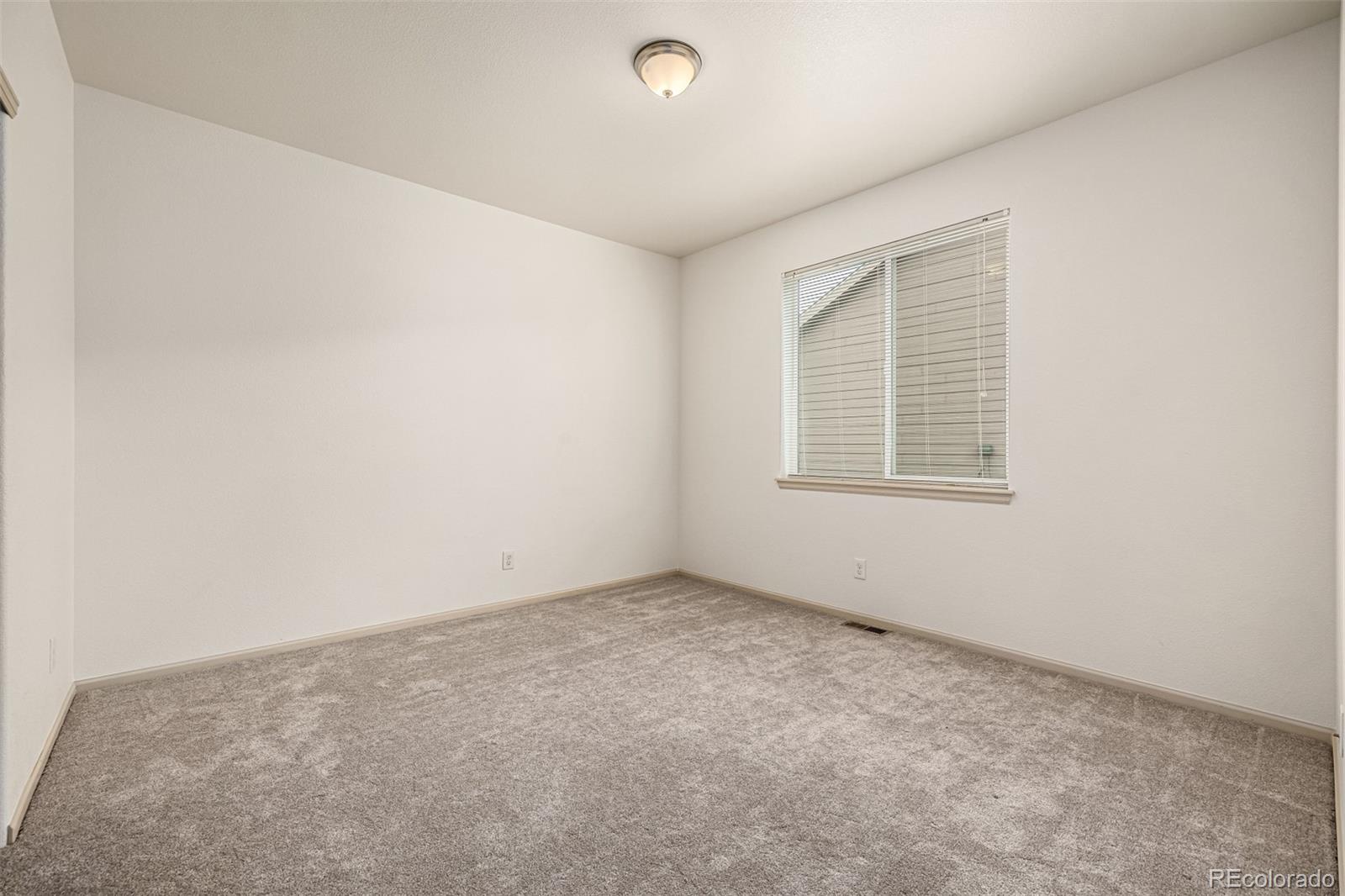 268 Naples Street Firestone, CO 80520 - Photo 21 of 34 an empty room with windows
