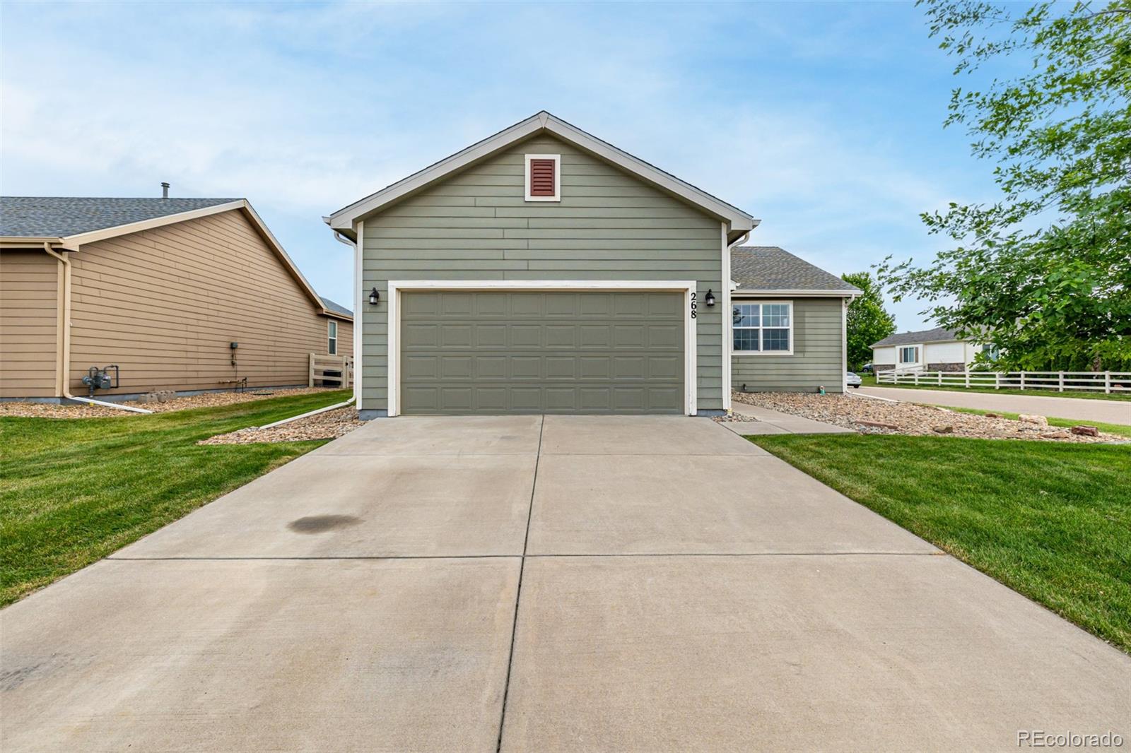 268 Naples Street Firestone, CO 80520 - Photo 32 of 34 a front view of house with yard and trees around