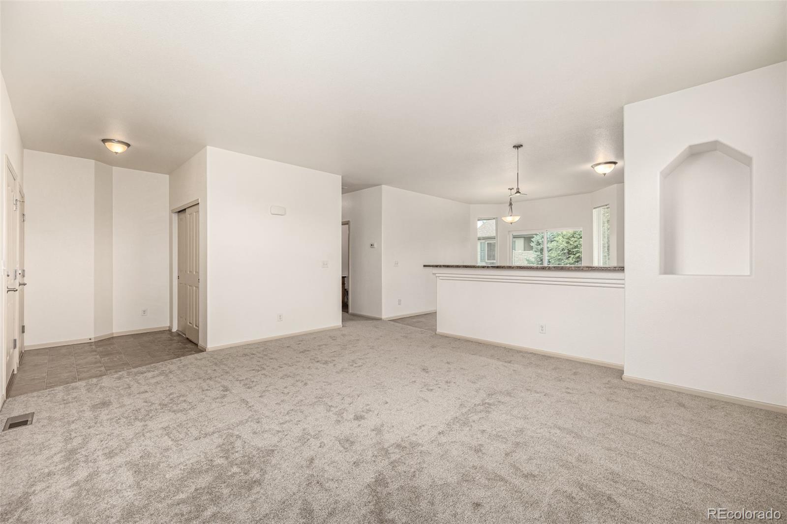 268 Naples Street Firestone, CO 80520 - Photo 6 of 34 a view of a kitchen with a sink and a refrigerator