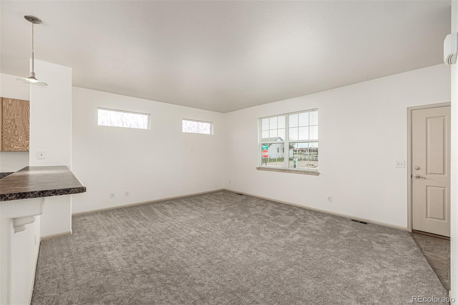 268 Naples Street Firestone, CO 80520 - Photo 8 of 34 an empty room with windows