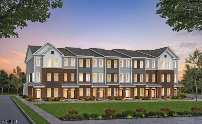 a front view of a residential apartment building with a yard