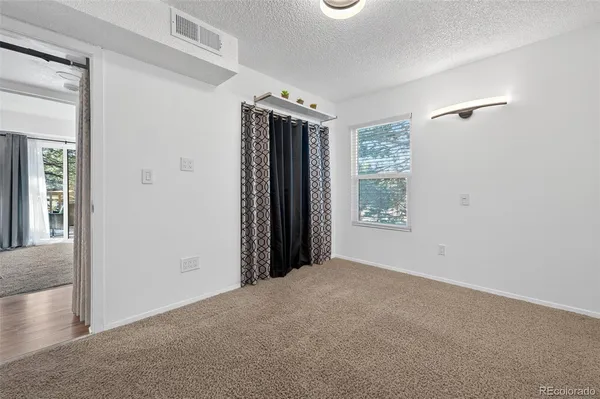 a bedroom with a bed a table and chair