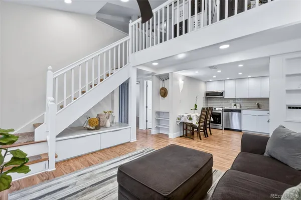 a kitchen with stainless steel appliances granite countertop a wooden cabinets a stove a sink and a wooden floors