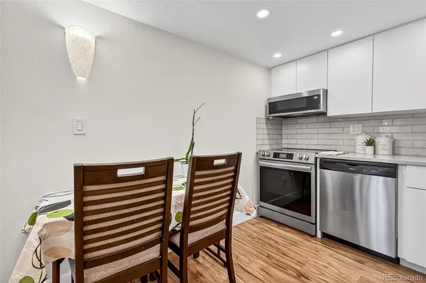 a kitchen with a refrigerator sink and cabinets