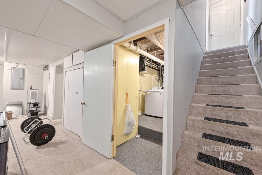 259 Highway 12 Pomeroy, WA 99347 - Photo 26 of 45 Carpeted staircase with risers, white panel door at landing, and light gray wall paneling