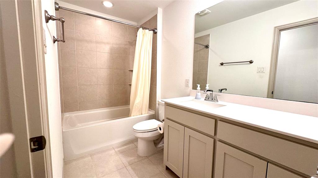 4683 B Rhett Lane Carrollton, TX 75010 - Photo 12 of 21 a bathroom with a sink a toilet and shower