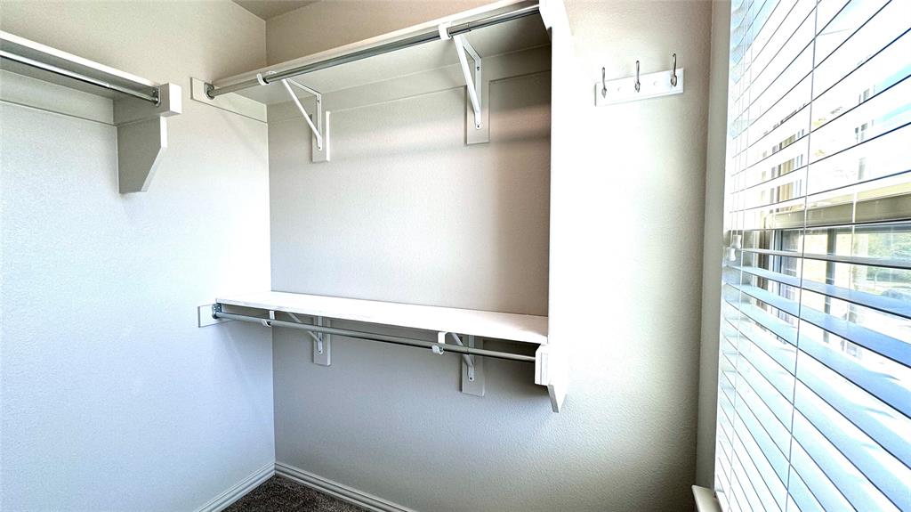 4683 B Rhett Lane Carrollton, TX 75010 - Photo 15 of 21 a view of a room with racks on the wall