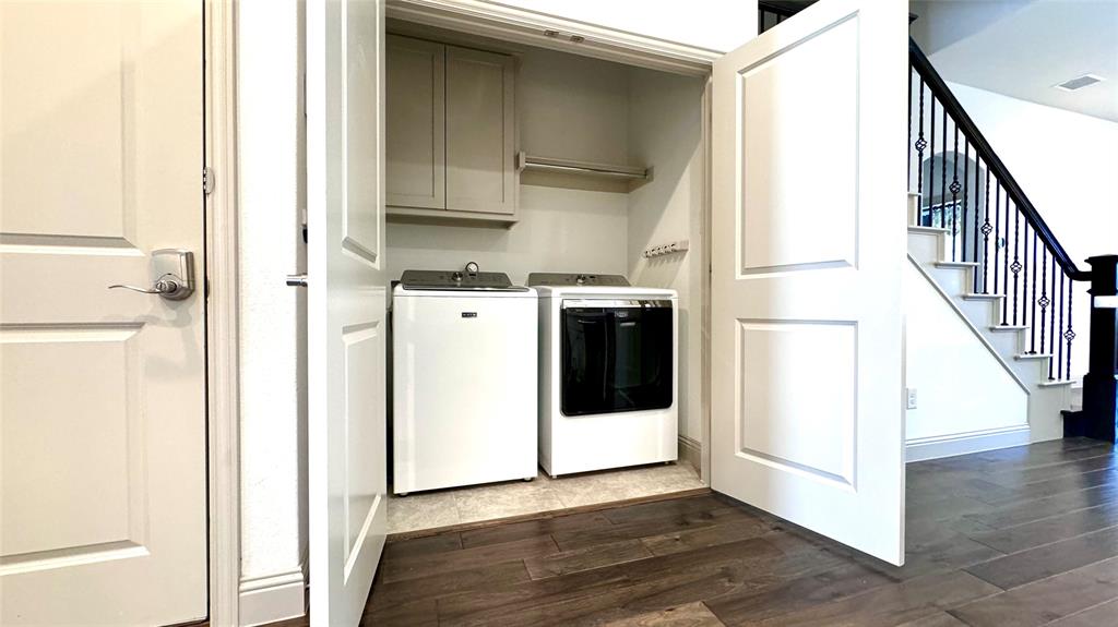 4683 B Rhett Lane Carrollton, TX 75010 - Photo 4 of 21 a view of a kitchen with wooden floor and electronic appliances