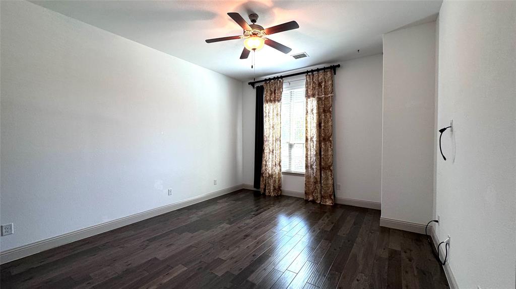 4683 B Rhett Lane Carrollton, TX 75010 - Photo 5 of 21 an empty room with wooden floor and windows