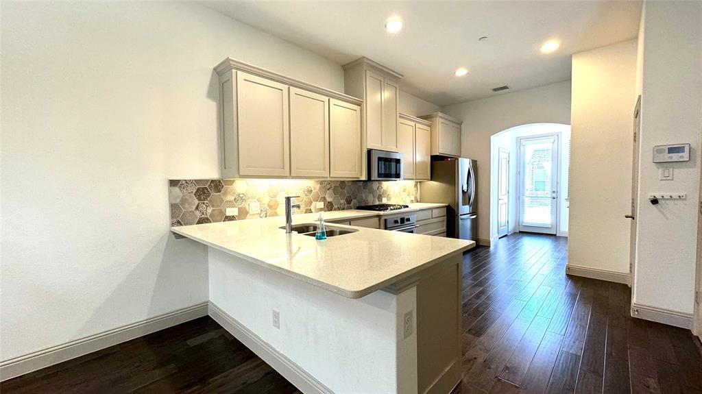 4683 B Rhett Lane Carrollton, TX 75010 - Photo 10 of 21 a kitchen with a sink stove and refrigerator