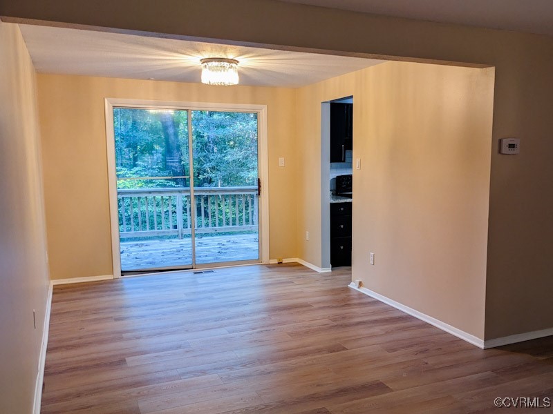 4600 Painted Post Lane Midlothian, VA 23112 - Photo 12 of 50 a view of an empty room with wooden floor and a window